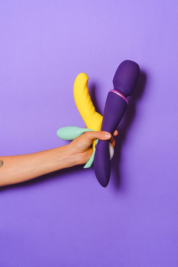 A hand holding dildos